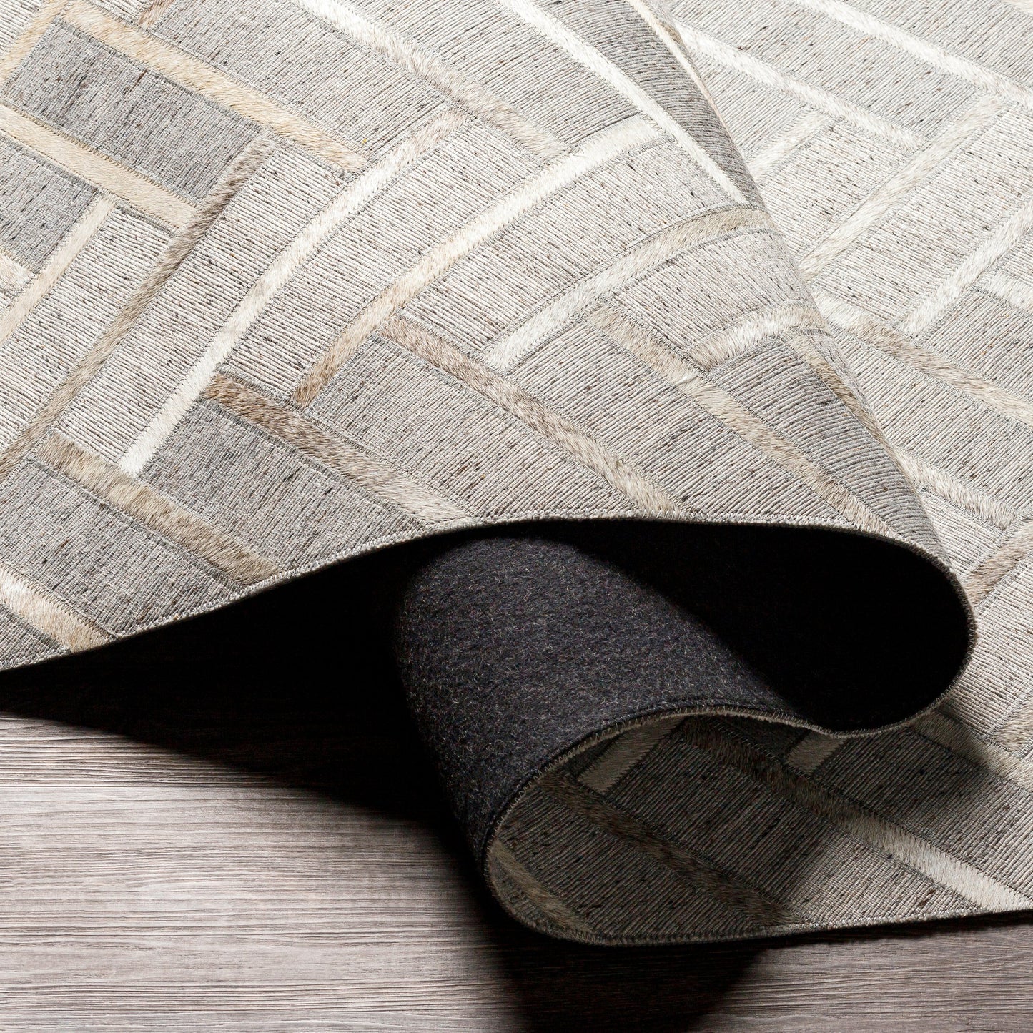 006 SI-1886227,SI-1886228,SI-1886229,SI-1886230 | Closeup | Medora Rug - 30192 by Surya in taupe, medium gray, oatmeal, tan, medium brown, light gray. Made from 65% viscose, 35% leather in a unique style.