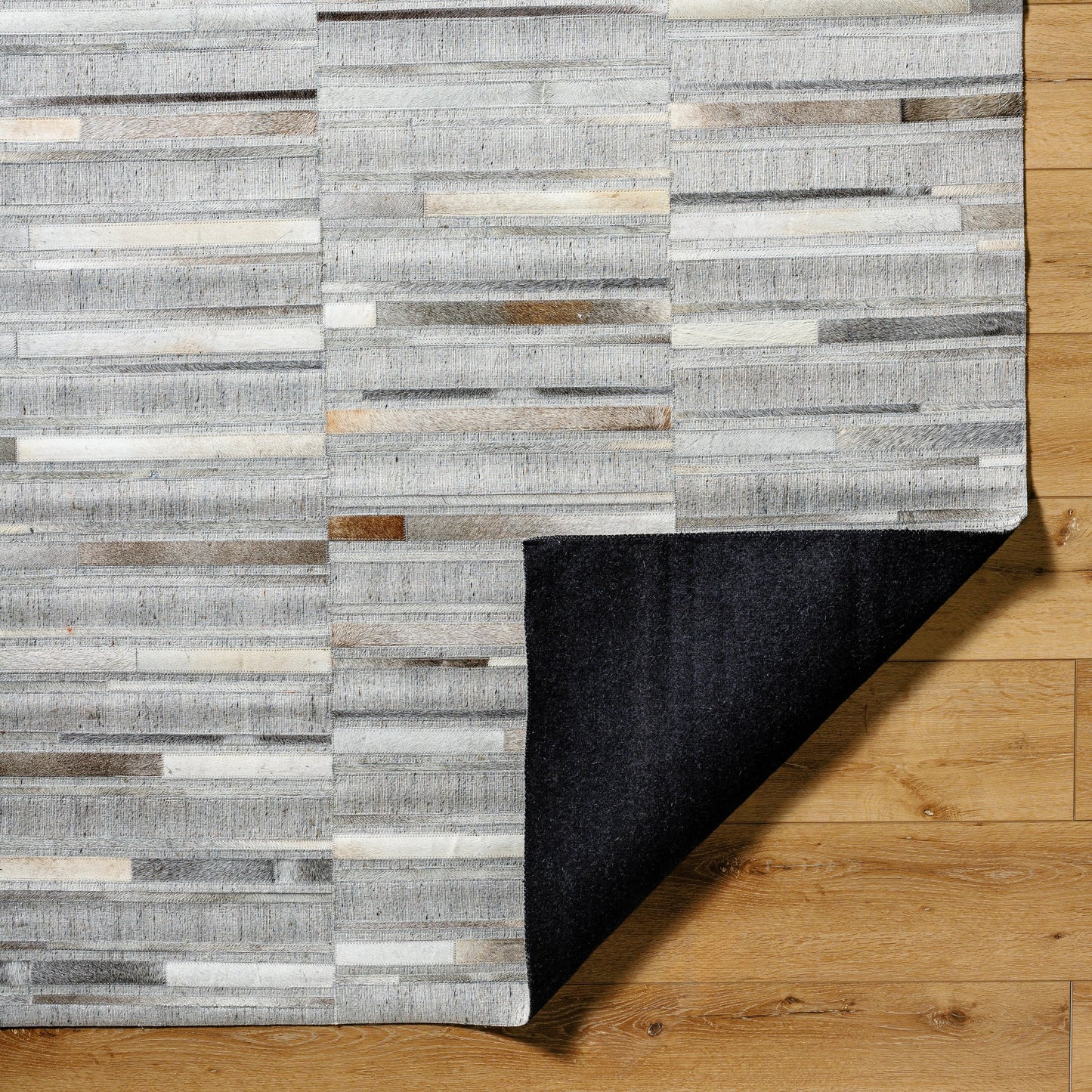 004 SI-2052144,SI-2052145,SI-2052146,SI-2052147 | Closeup | Medora Rug - 489431 by Surya in taupe, ivory, stone grey, charcoal. Made from face: 60% leather, 40% viscose in a unique style.
