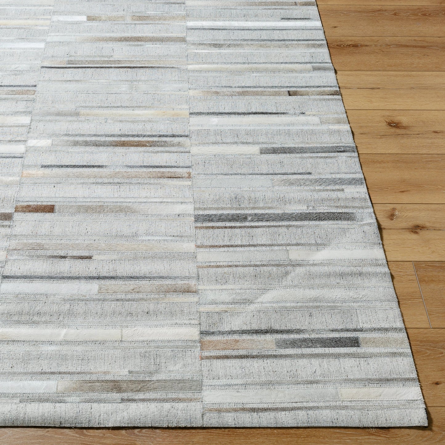 005 SI-2052144,SI-2052145,SI-2052146,SI-2052147 | Closeup | Medora Rug - 489431 by Surya in taupe, ivory, stone grey, charcoal. Made from face: 60% leather, 40% viscose in a unique style.