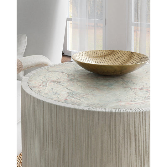 Serenity Swale Round Side Table by Hooker Furniture in light gray. Made from wood, resin, honed marble veneer with slight sandblasting in a modern style.