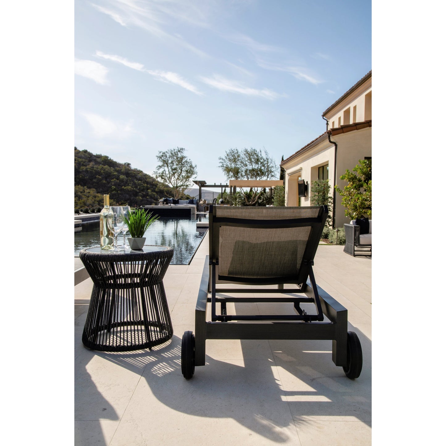 007 SI-2166977 | Lifestyle | Redondo Outdoor Adjustable Sling Chaise by Sunset West in slate. Made from aluminum in a modern style.