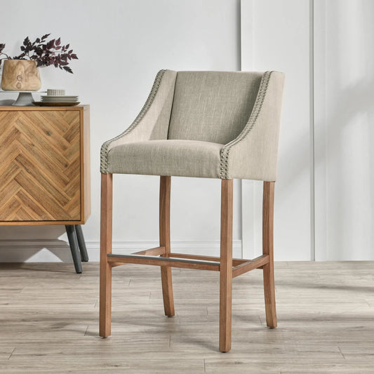 Castaic Upholstered Barstool by Kosas Home in french beige upholstery, honey brown legs. Made from blended upholstery (57% polyester 25% viscose 18% linen), rubber wood legs in a transitional style.