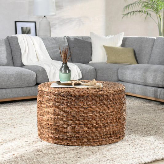 Ira Round Rattan Coffee Table by Kosas Home. Made from rattan abaca in a coastal style.