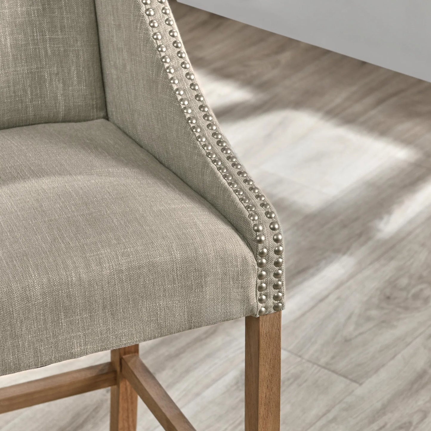 006 SR-897676 | Closeup | Castaic Counter Stool by Kosas Home in french beige, honey brown. Made from blended upholstery (28% linen, 18% polyester, 54% velvet, rubber wood legs in a modern style.