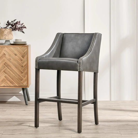 Castaic Leather Barstool by Kosas Home in charcoal gray upholstery, brown legs. Made from inspired leather upholstery, rubberwood legs in a modern style.