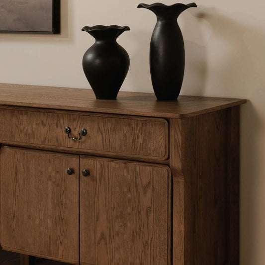 Caroline Sideboard by Moe's Home Collection in warm brown. Made from solid oak frame, oak veneer over mdf side panel, drawer in a transitional style.