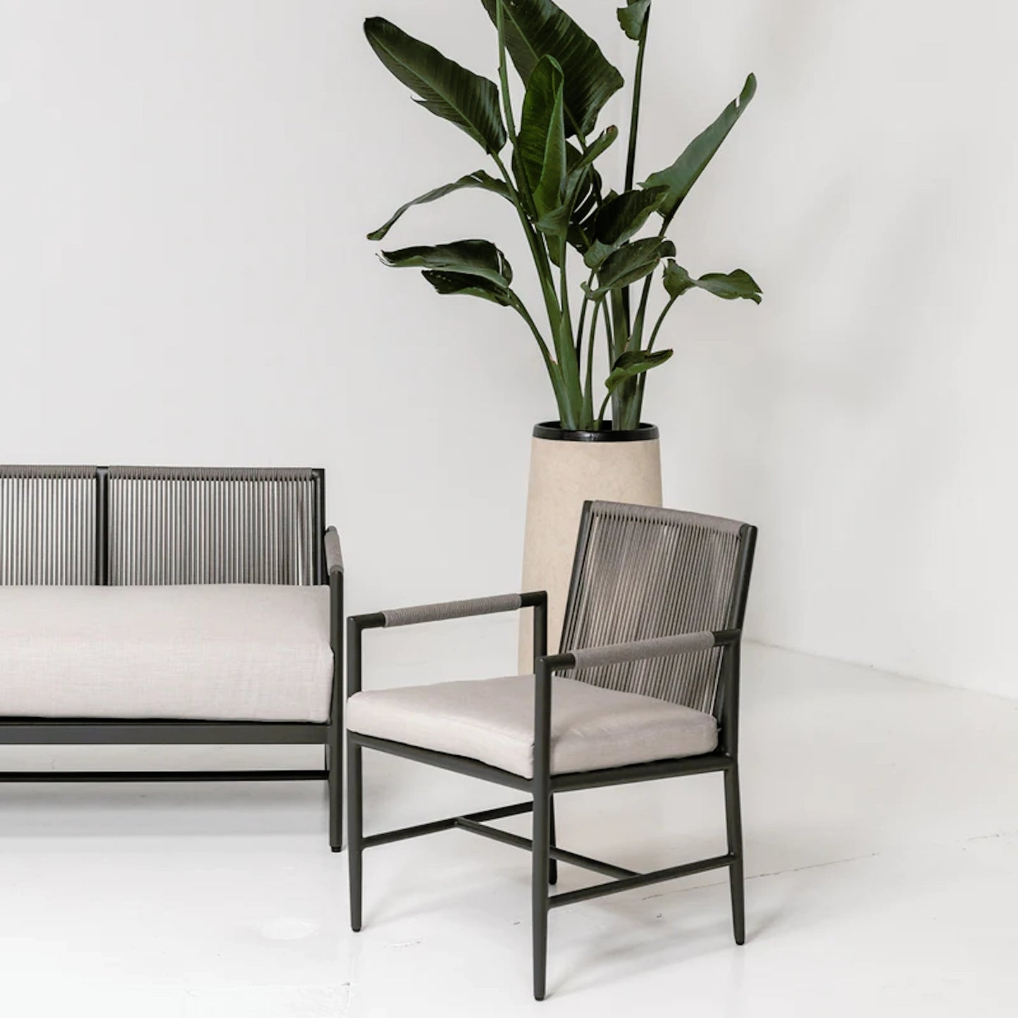 006 SI-2167094 | Lifestyle | Pietra Outdoor Armless Dining Chair by Sunset West in graphite. Made from olefin rope in a modern style.