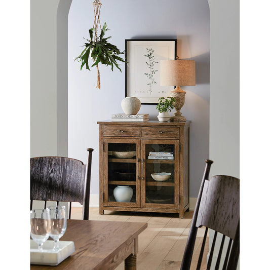 Americana Pie Chest by Hooker Furniture in brown and honey finish. Made from oak veneer with light, seeded glass and tempered glass in a modern style.