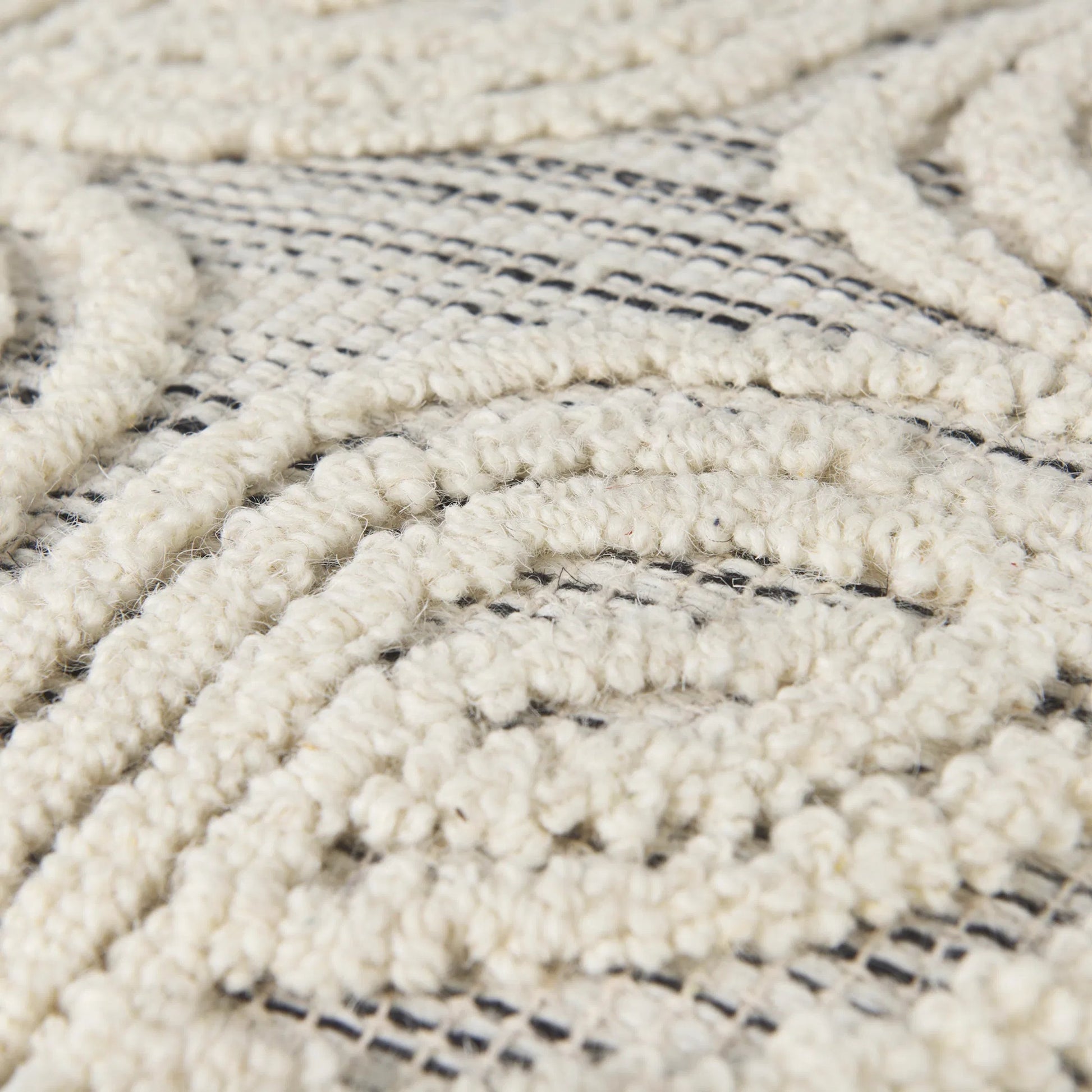 Amaya Pouf by Mercana in cream. Made from wool in a rustic style.