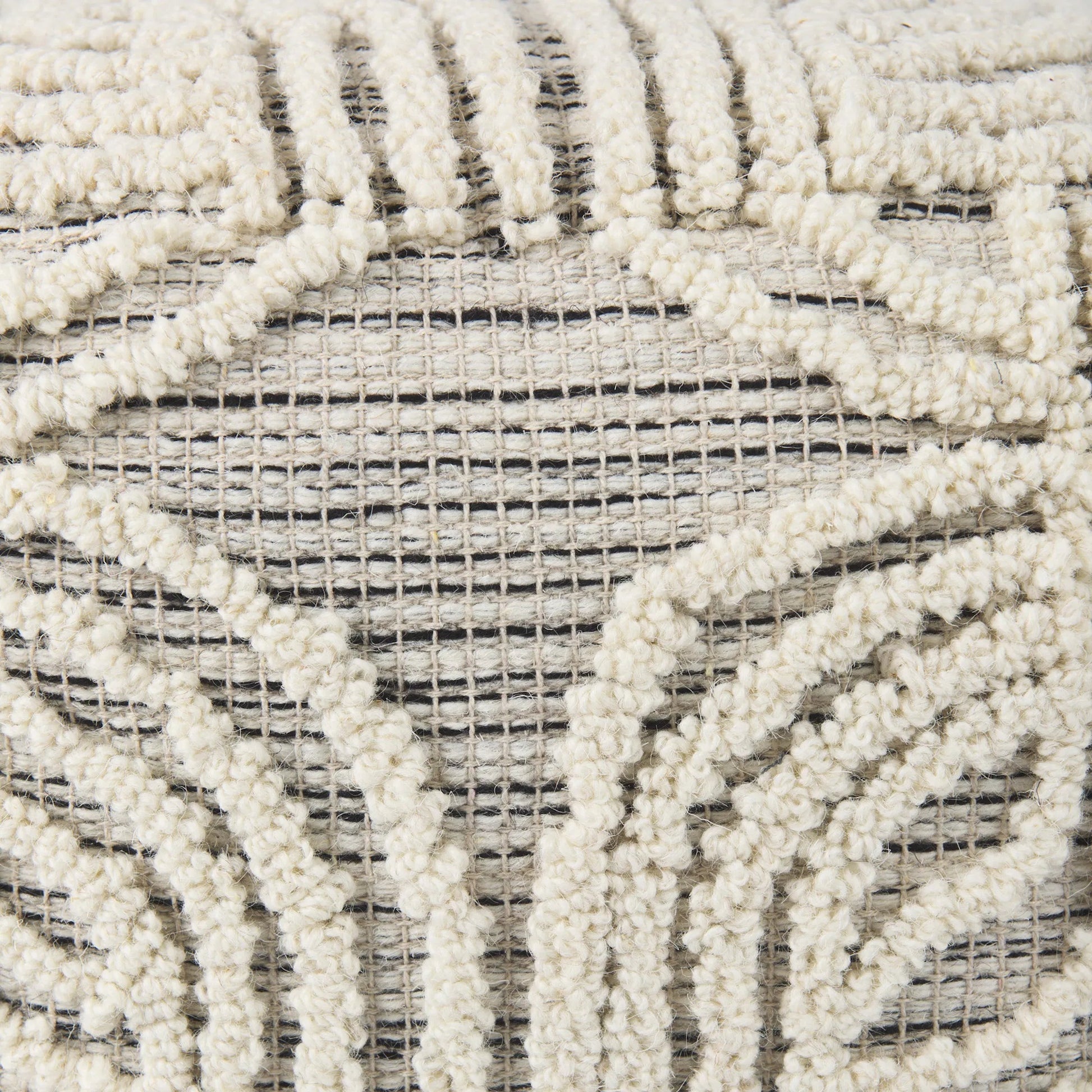 Amaya Pouf by Mercana in cream. Made from wool in a rustic style.