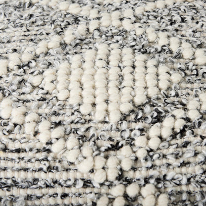 Ekiya Pouf by Mercana in gray, white. Made from wool in a rustic style.