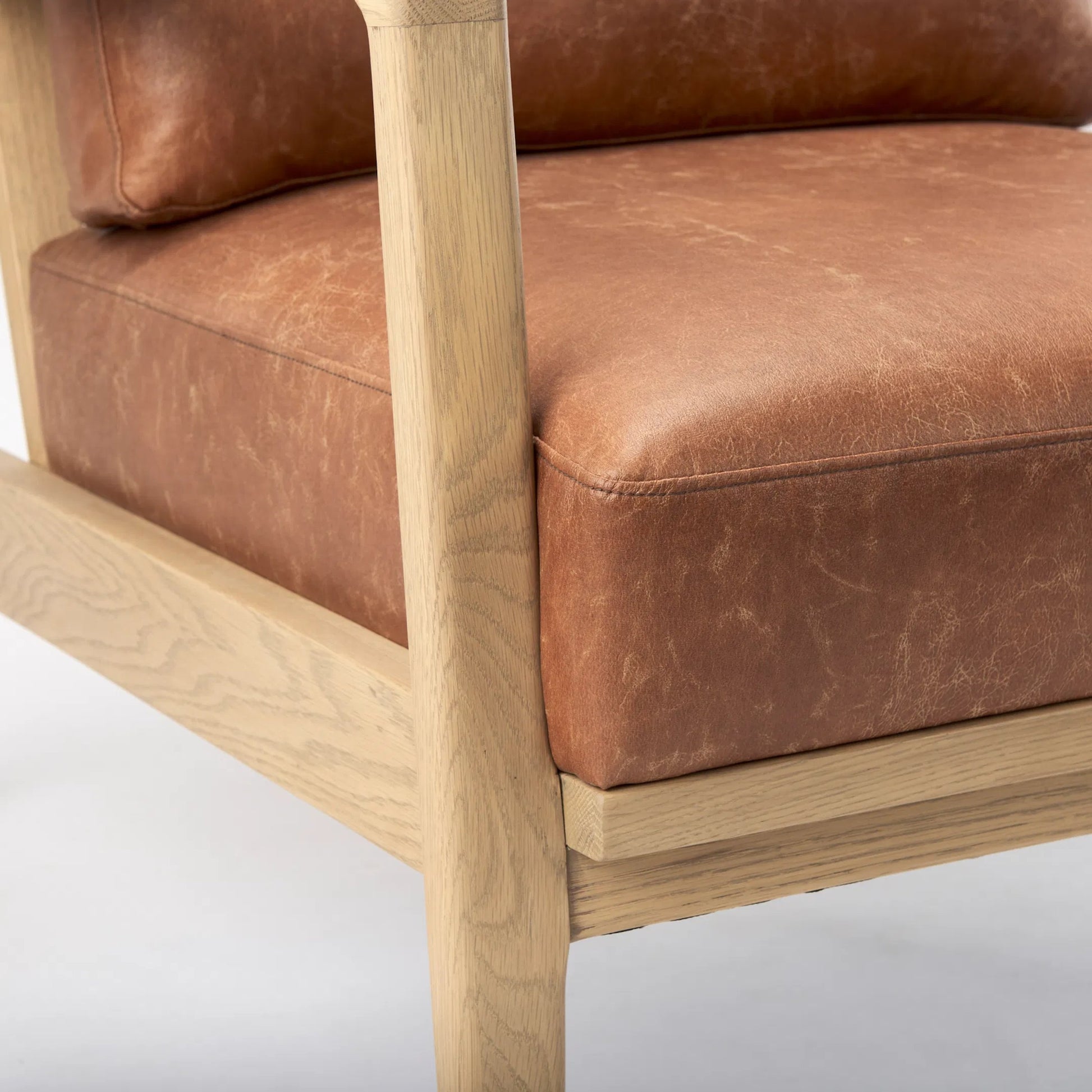 Raeleigh Leather Accent Chair by Mercana in tan. Made from fabric in a traditional style.