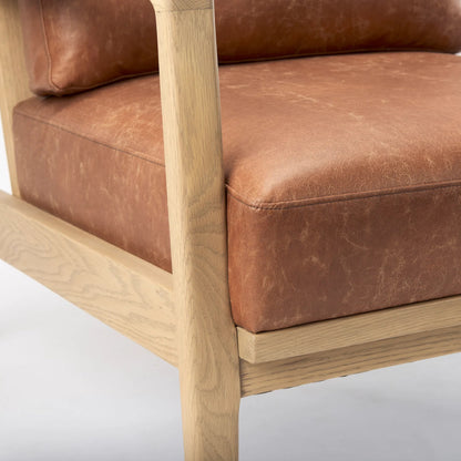 Raeleigh Leather Accent Chair by Mercana in tan. Made from fabric in a traditional style.