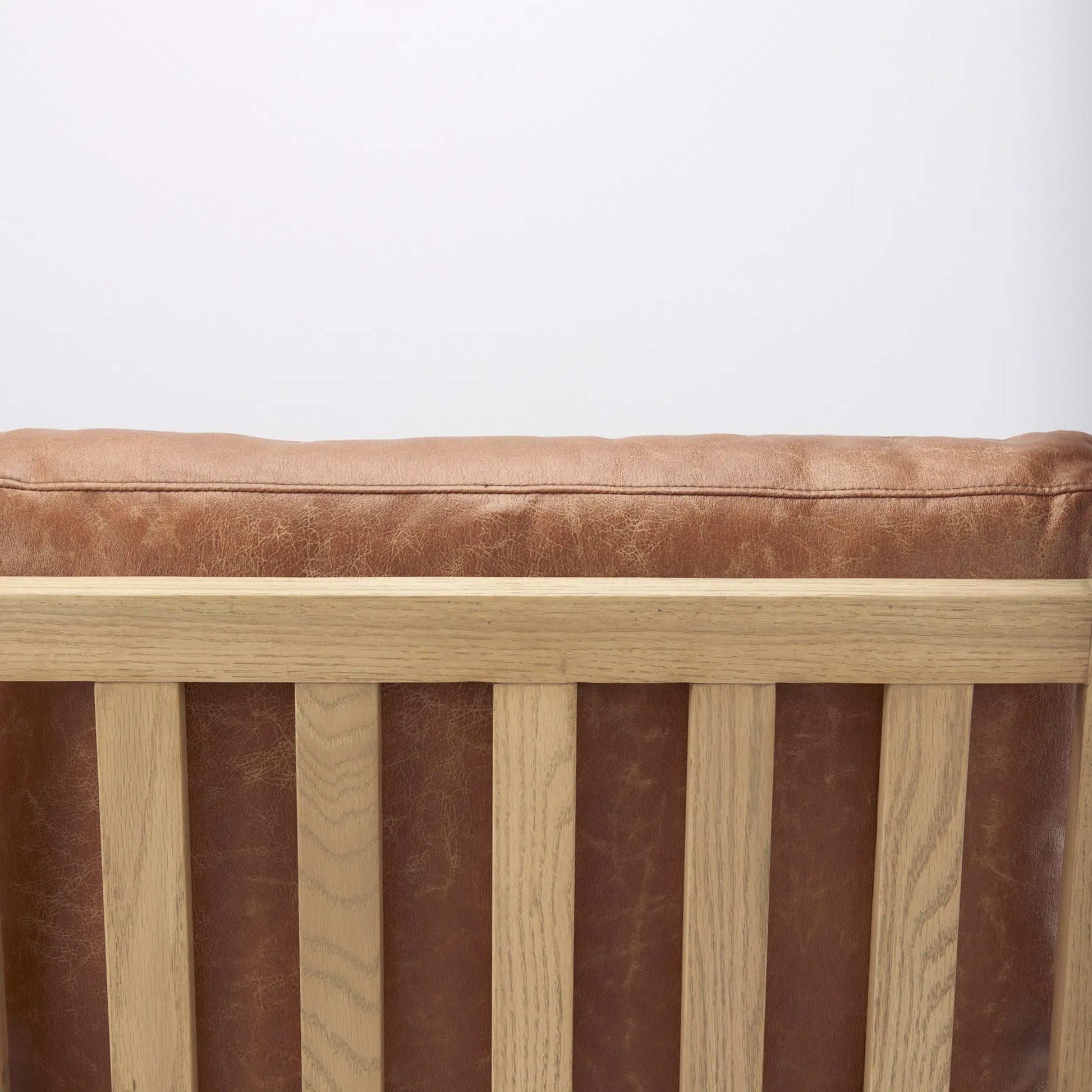 Raeleigh Leather Accent Chair by Mercana in tan. Made from fabric in a traditional style.