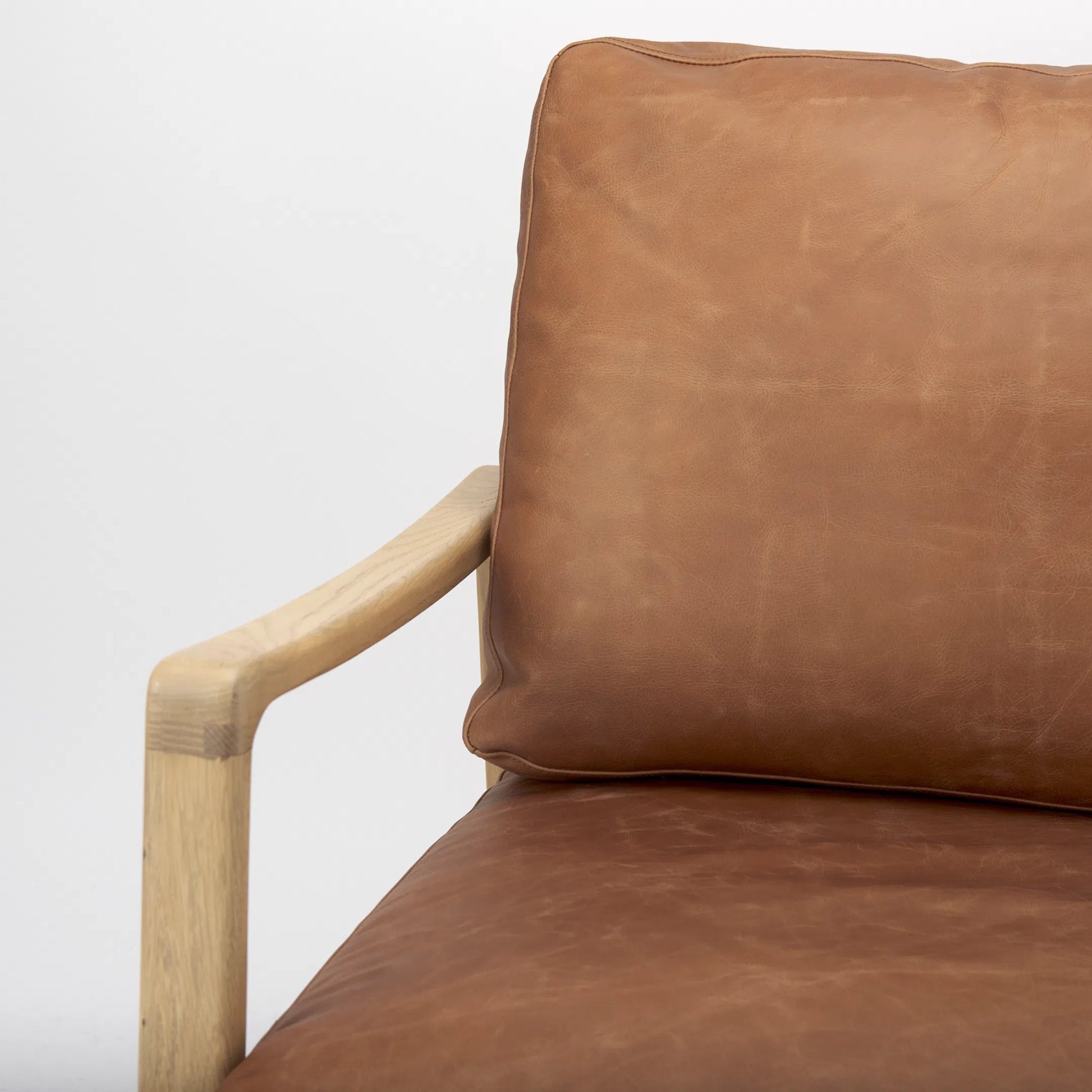 Raeleigh Leather Accent Chair by Mercana in tan. Made from fabric in a traditional style.