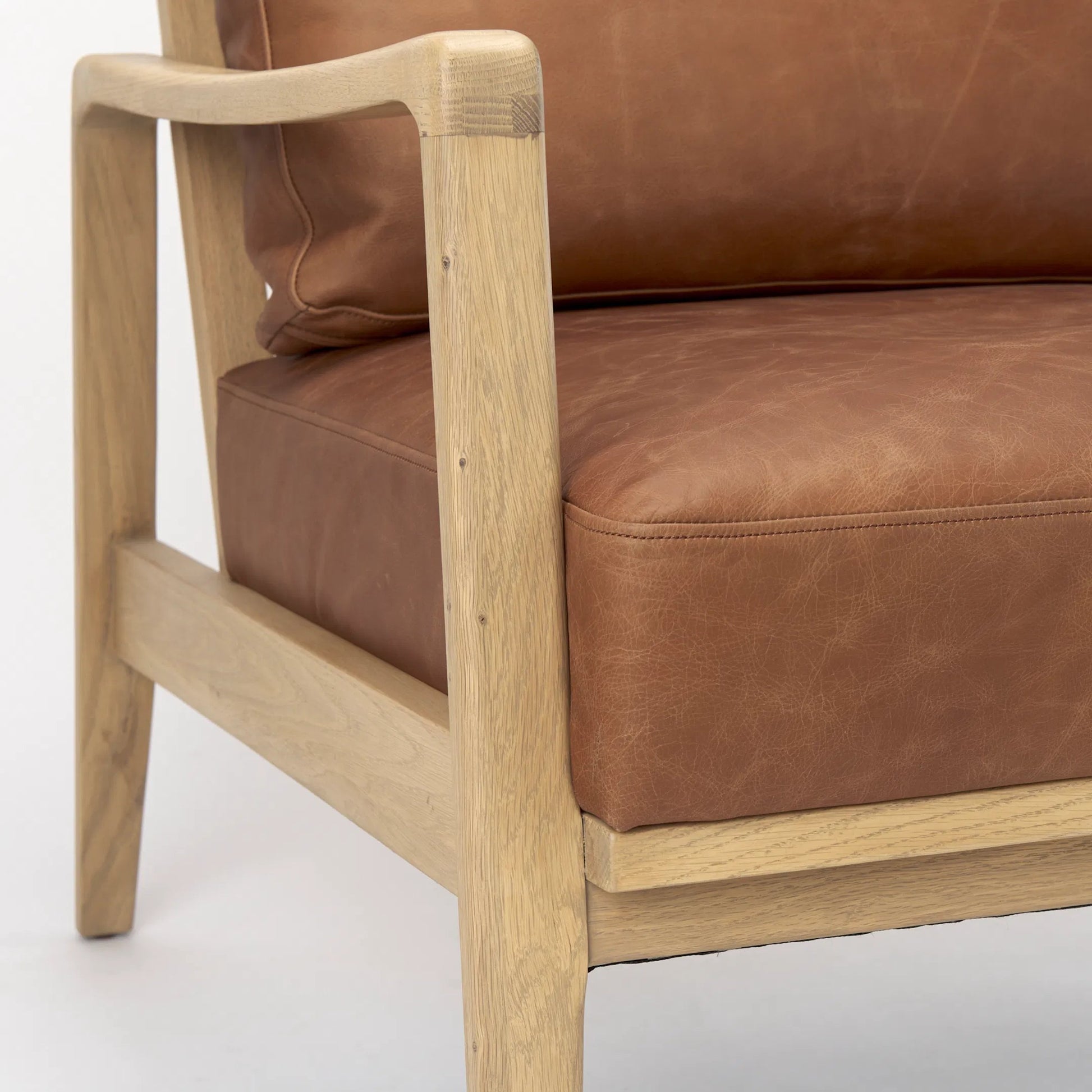 Raeleigh Leather Accent Chair by Mercana in tan. Made from fabric in a traditional style.