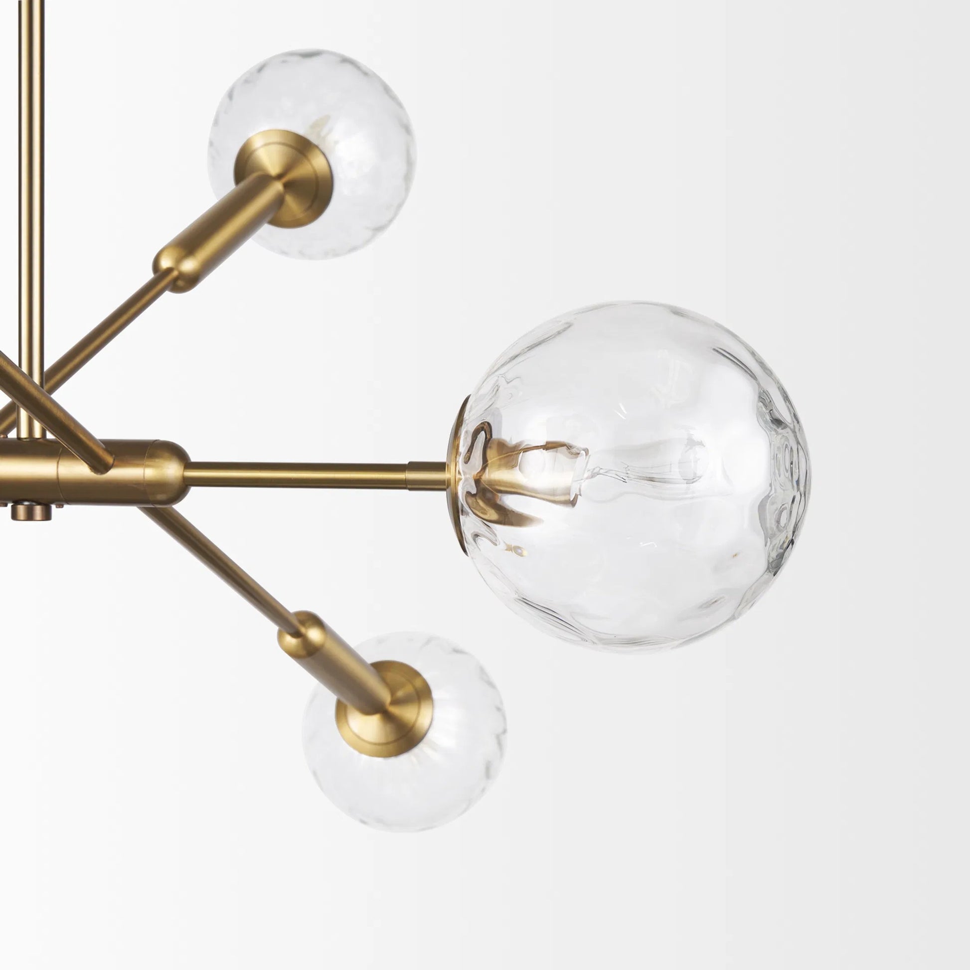 Britton Chandelier by Mercana in gold. Made from glass, metal in a modern style.