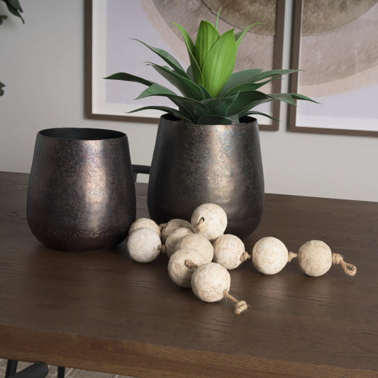 Quade Planter by Mercana in gold. Made from metal in a modern style.