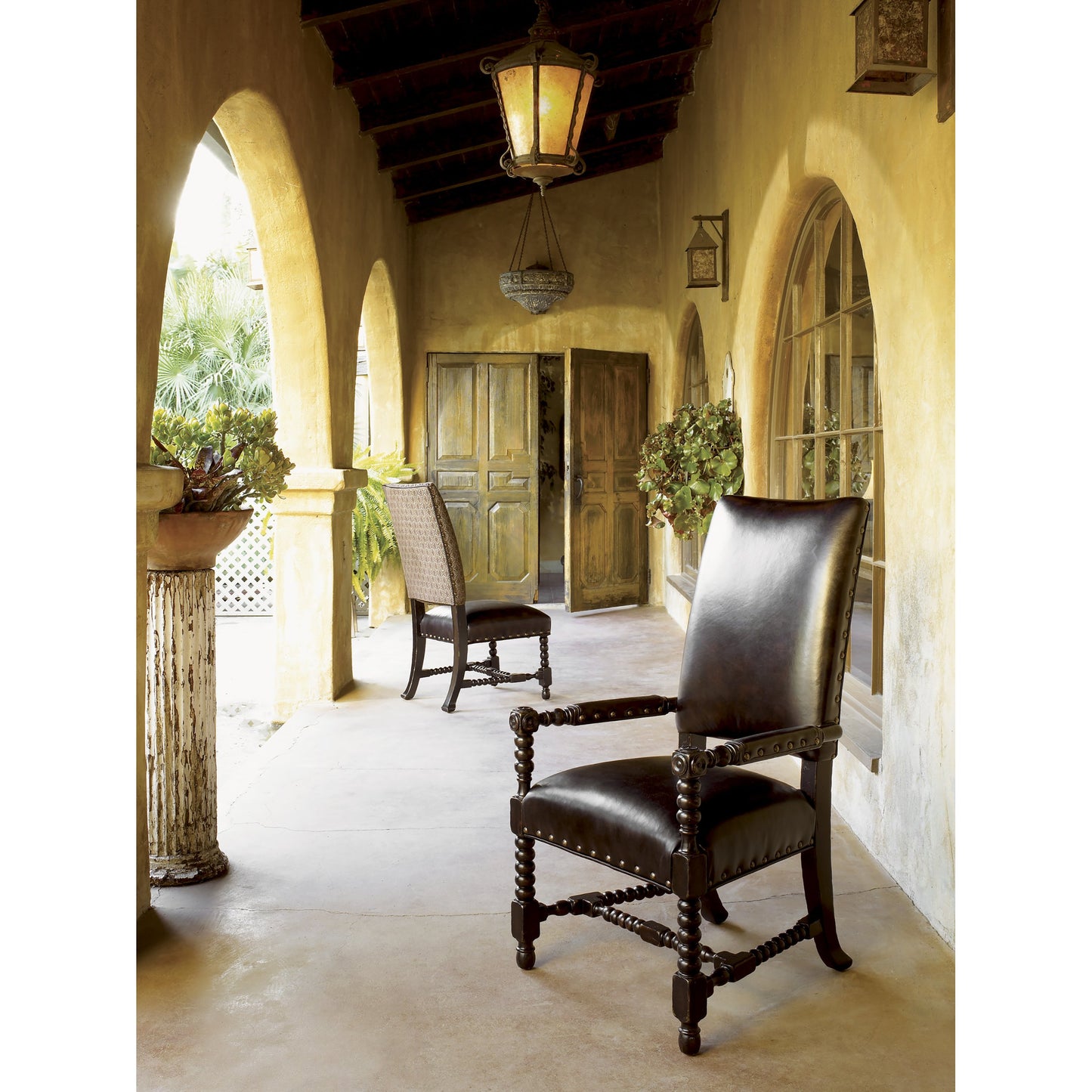 003 SR-836085 | Lifestyle | Edwards Arm Chair by Tommy Bahama Home in antiqued brown leather. Made from unique in a eclectic & global style.