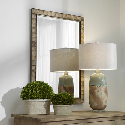 Cocos Mirror by Uttermost in dark gold. Made from iron, glass coconut shell, mdf in a transitional style.