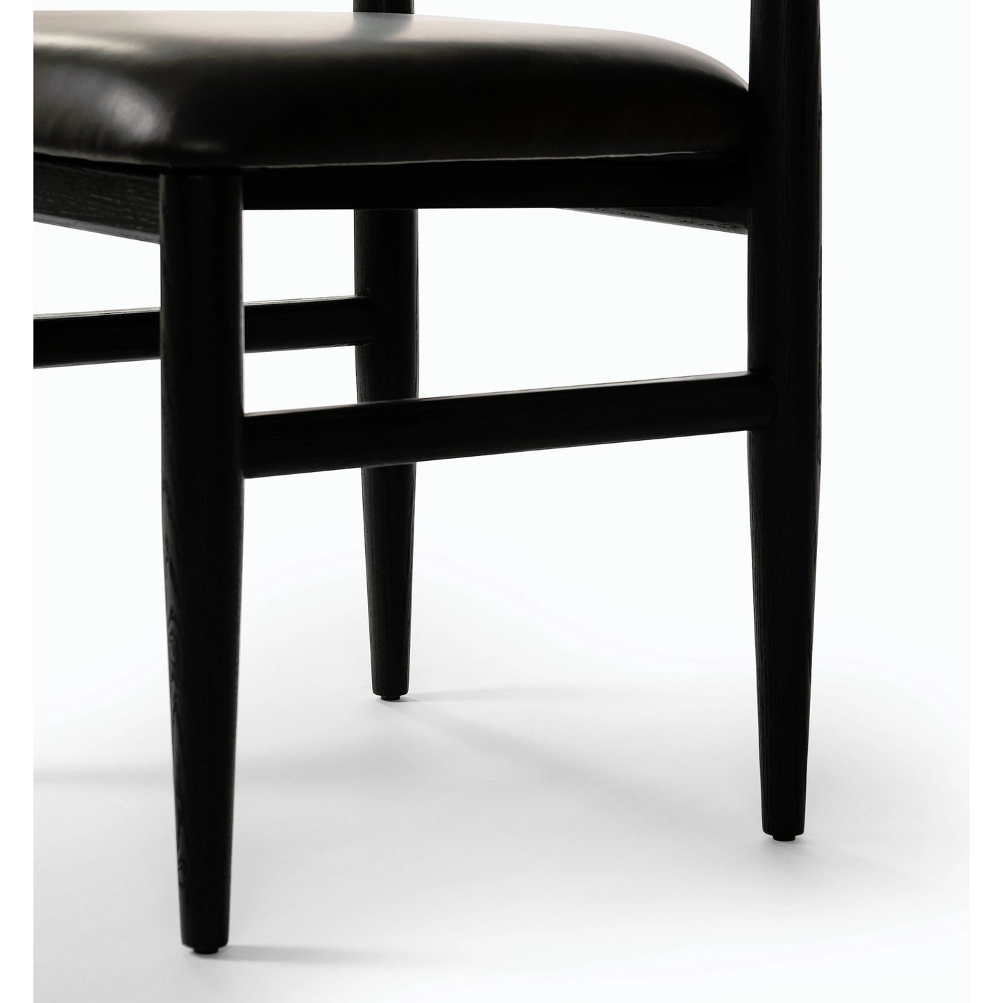 008 SI-2158296 | Closeup | Mavery Armless Dining Chair by Four Hands in sierra espresso, brushed ebony oak, brushed ebony oak veneer. Made from faux leather, solid oak, oak veneer in a modern style.