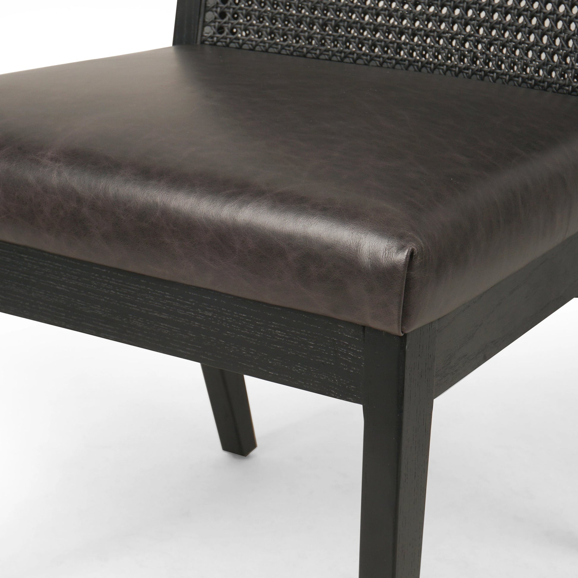 Antonia Cane Dining Chair by Four Hands in brushed ebony, sonoma black. Made from top grain leather, solid nettlewood, cane in a modern style.
