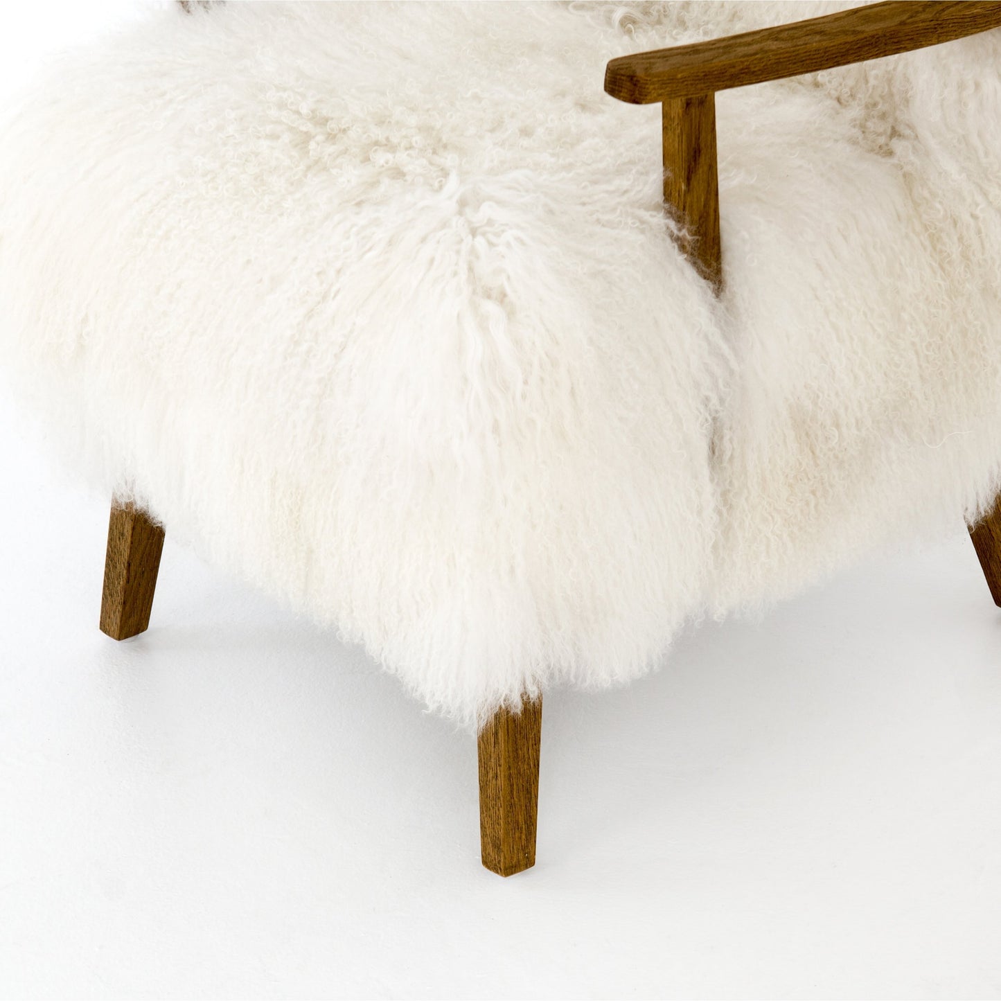 017 SI-1797380 | Closeup | Ashland Armchair by Four Hands in mongolia cream fur, drifted oak. Made from mongolia fur, solid oak, 100% polyester in a modern style.