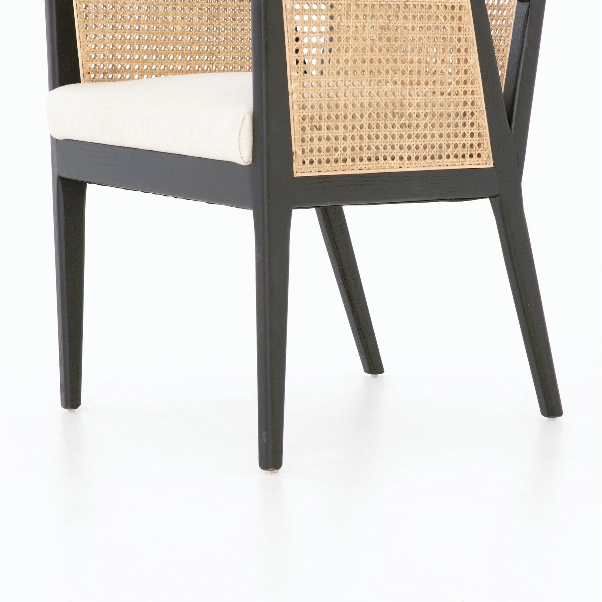 Antonia Cane Dining Armchair by Four Hands in light natural cane, brushed ebony, savile flax. Made from 92% polyester, 8% flax, linen, solid nettlewood, cane in a modern style.