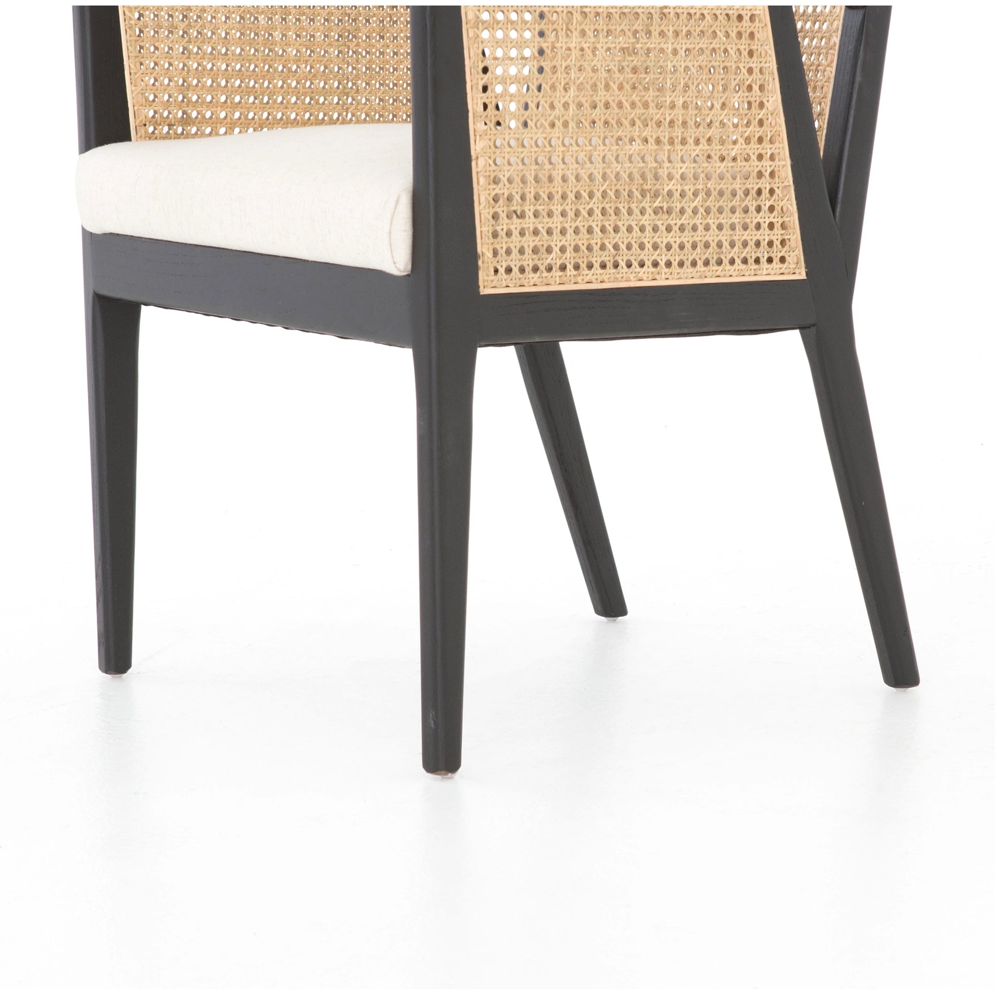 Antonia Cane Dining Armchair by Four Hands in light natural cane, brushed ebony, savile flax. Made from 92% polyester, 8% flax, linen, solid nettlewood, cane in a modern style.