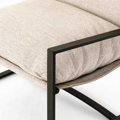 Avon Outdoor Sling Chair by Four Hands in faye sand, bronze. Made from 100% olefin, aluminum, 59% polyurethane foam, 30% polyester fiber, 11% polyester fiber batting in a modern style.