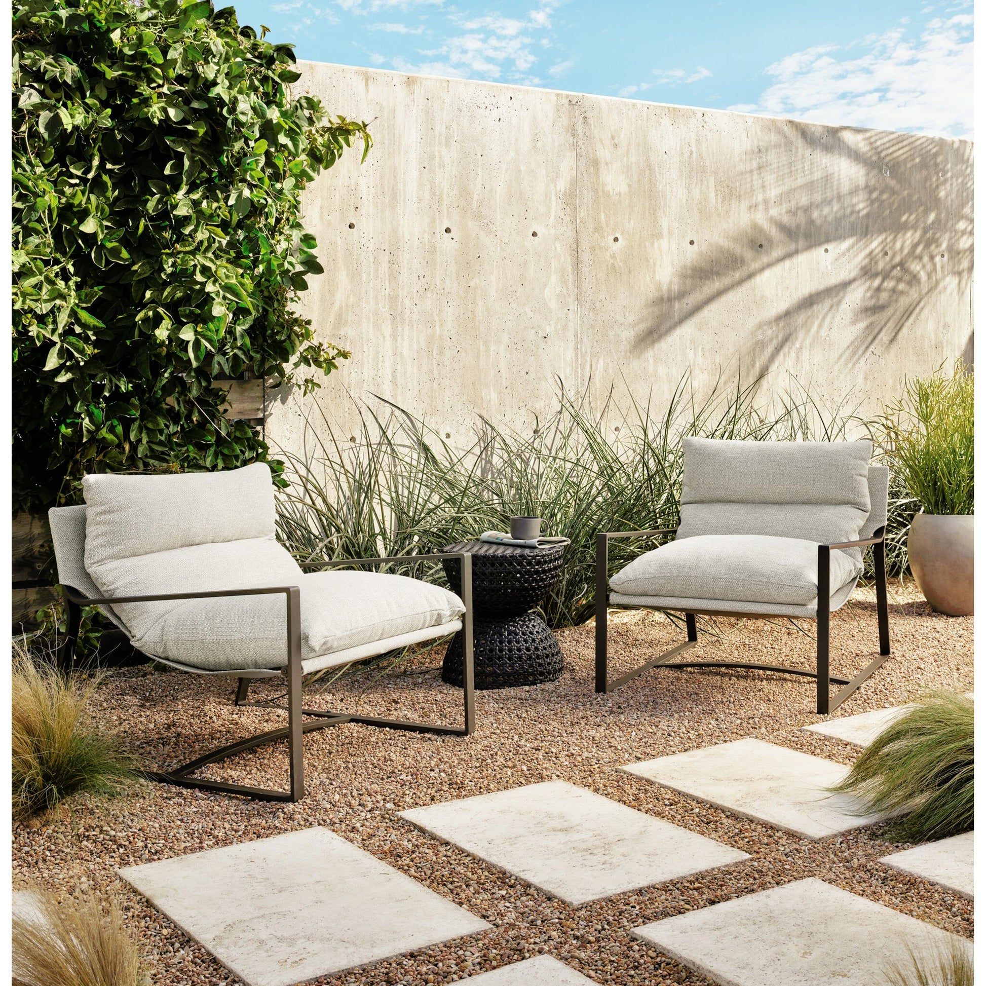 Avon Outdoor Sling Chair by Four Hands in faye sand, bronze. Made from 100% olefin, aluminum, 59% polyurethane foam, 30% polyester fiber, 11% polyester fiber batting in a modern style.