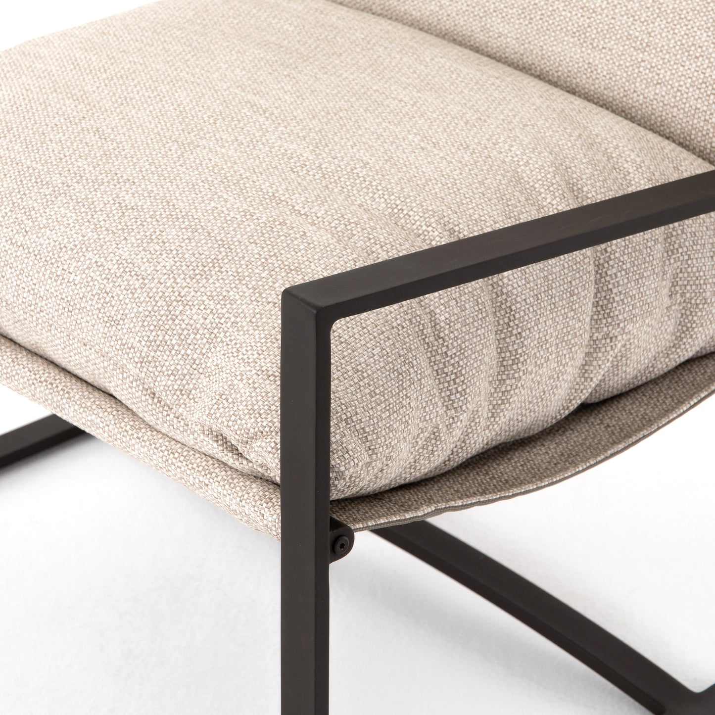 017 SI-1902072 | Closeup | Avon Outdoor Sling Chair by Four Hands in faye sand, bronze. Made from 100% olefin, aluminum, 59% polyurethane foam, 30% polyester fiber, 11% polyester fiber batting in a modern style.