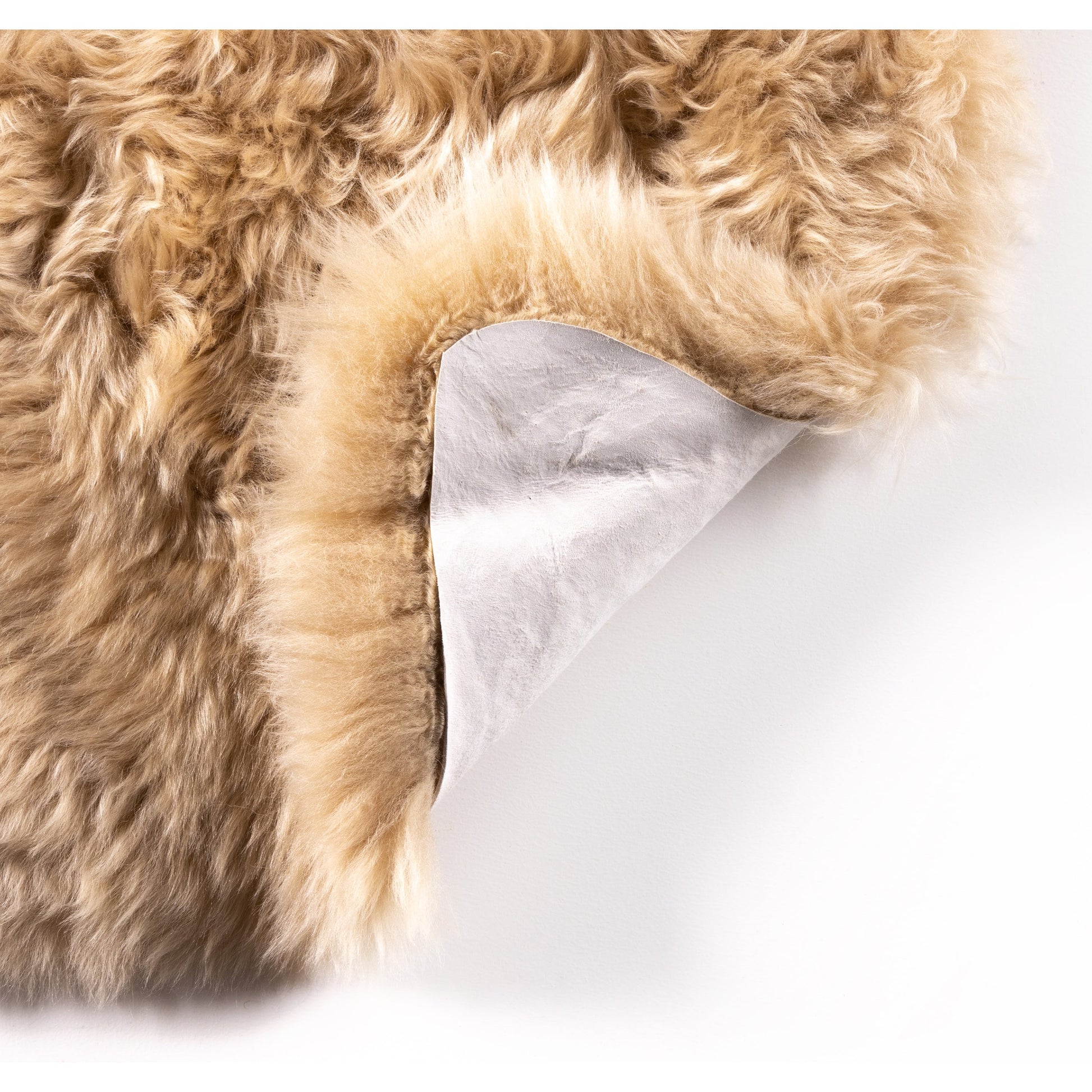 Lalo Lambskin Throw by Four Hands. Made from shearling in a rustic style.
