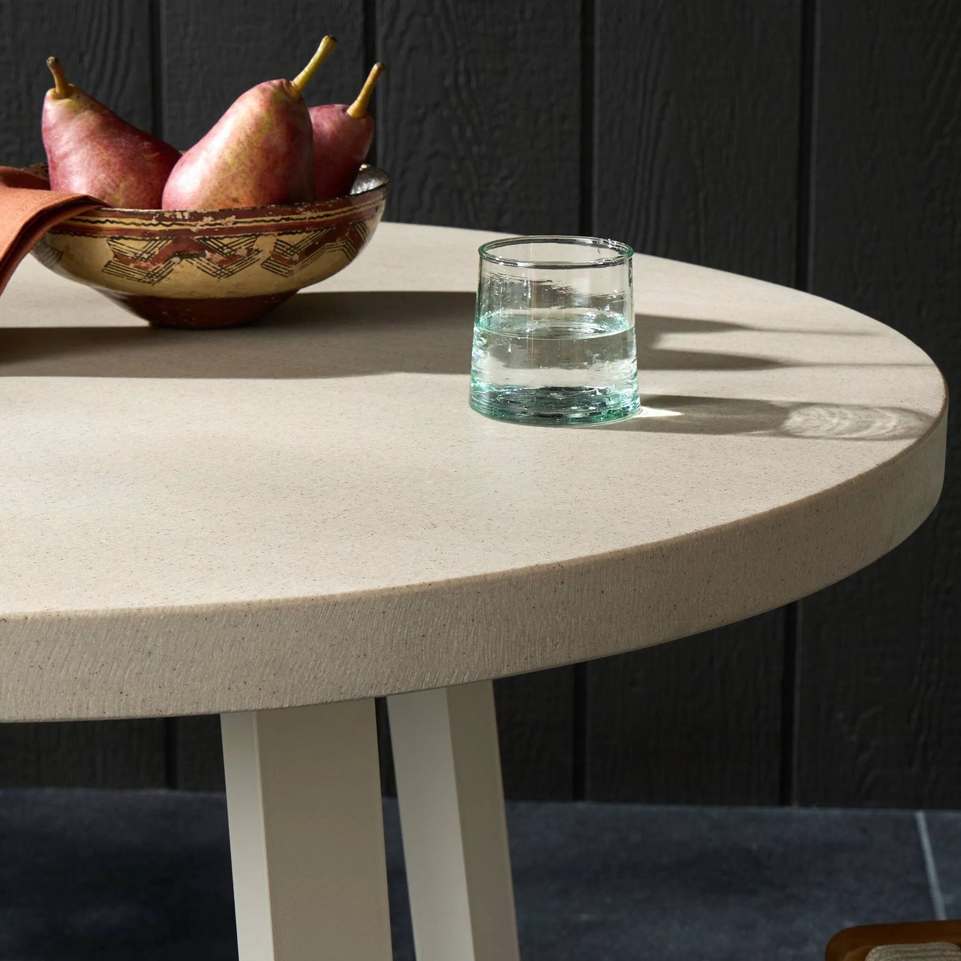 Cyrus Outdoor Round Dining Table by Four Hands. Made from lavastone composite, iron in a modern style.