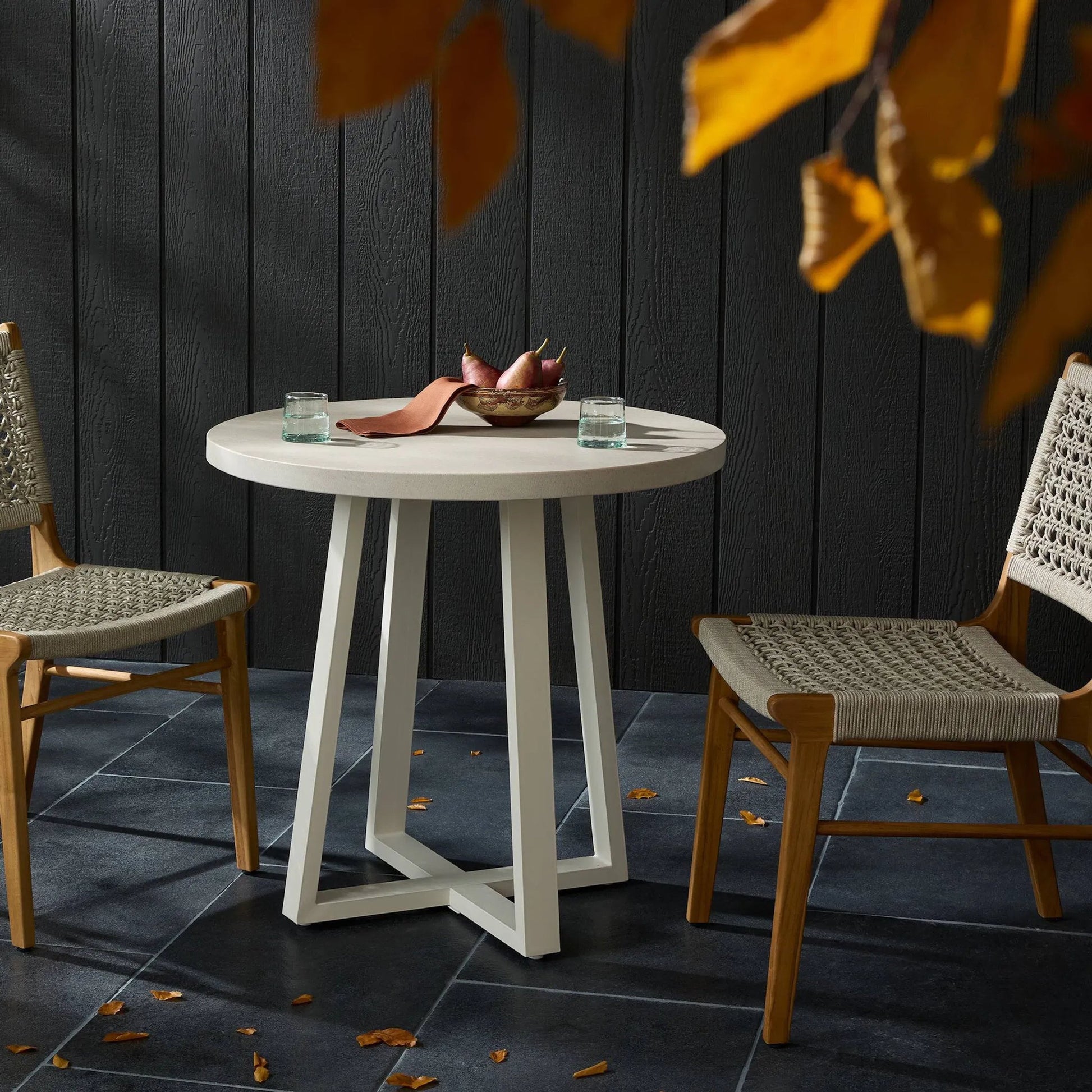 Cyrus Outdoor Round Dining Table by Four Hands. Made from lavastone composite, iron in a modern style.