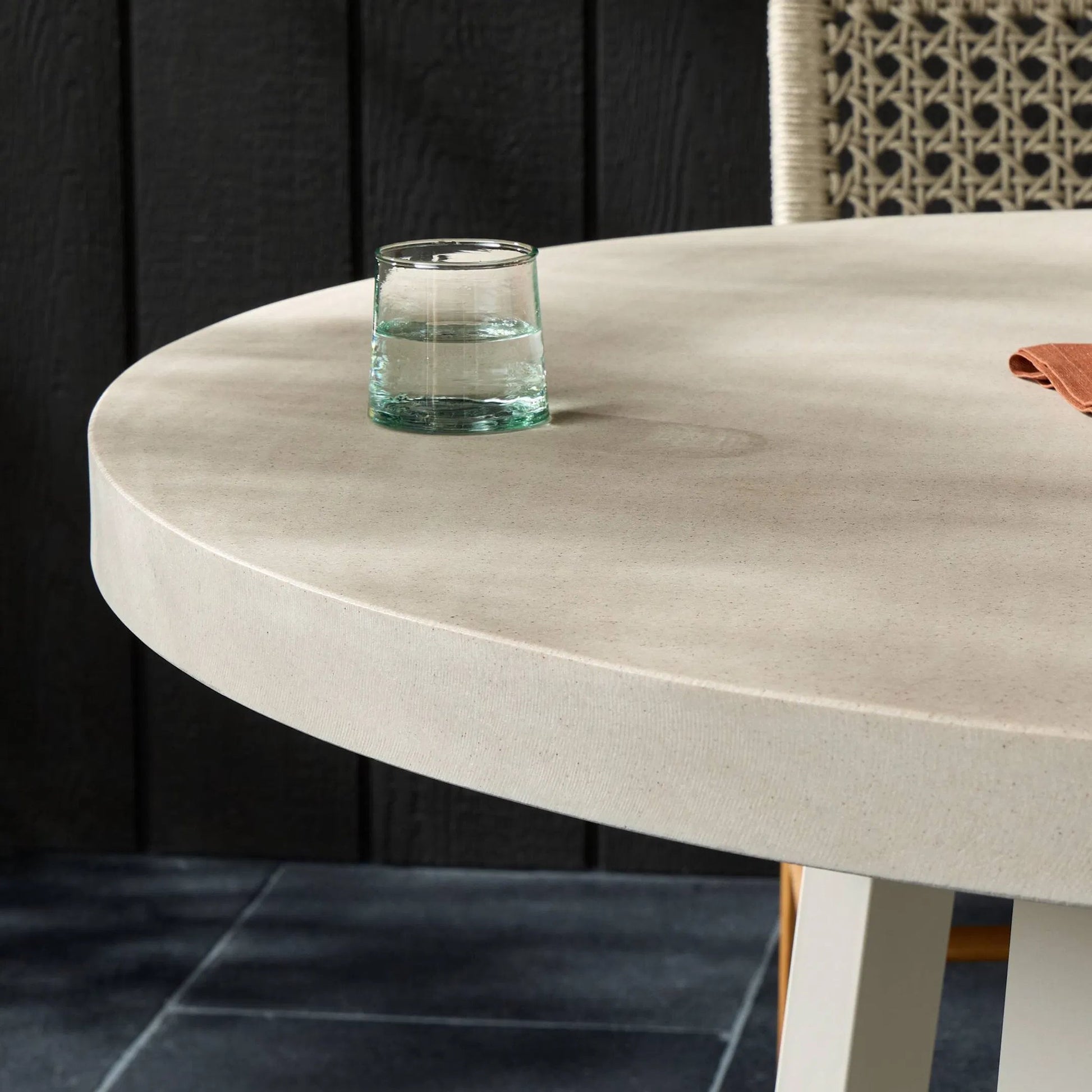 Cyrus Outdoor Round Dining Table by Four Hands. Made from lavastone composite, iron in a modern style.