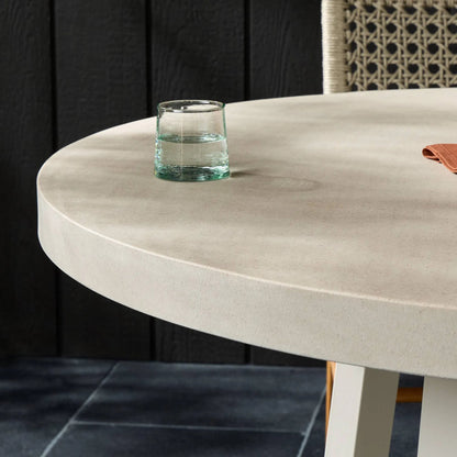 Cyrus Outdoor Round Dining Table by Four Hands. Made from lavastone composite, iron in a modern style.