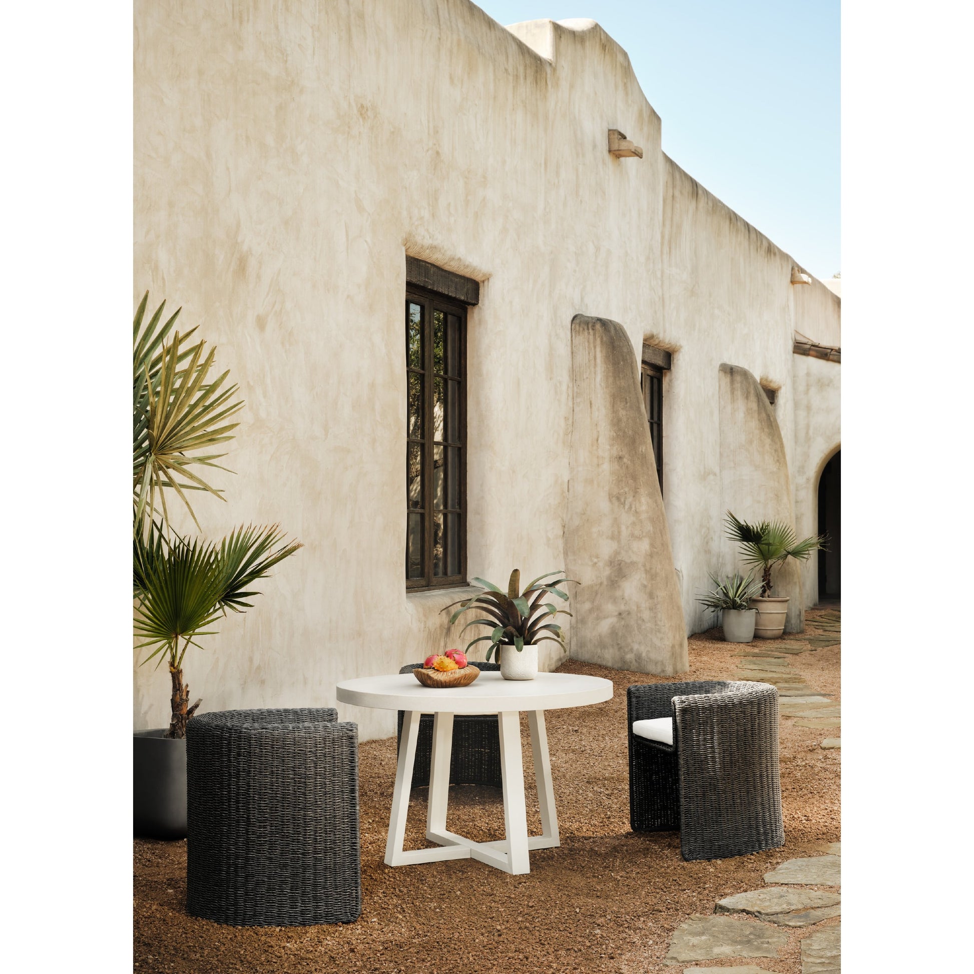 Cyrus Outdoor Round Dining Table by Four Hands. Made from lavastone composite, iron in a modern style.