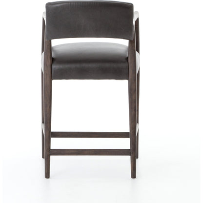 Tyler Counter Stool by Four Hands in chaps ebony, burnt oak. Made from top grain leather, solid nettlewood, 100% polyester in a modern style.