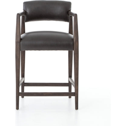 Tyler Counter Stool by Four Hands in chaps ebony, burnt oak. Made from top grain leather, solid nettlewood, 100% polyester in a modern style.