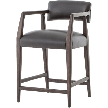 Tyler Counter Stool by Four Hands in chaps ebony, burnt oak. Made from top grain leather, solid nettlewood, 100% polyester in a modern style.