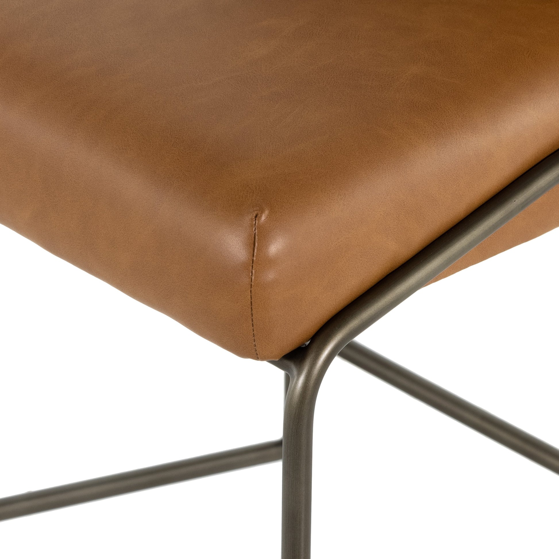 Astrud Bar Stool by Four Hands in sierra butterscotch. Made from faux leather, iron, top grain leather in a modern style.