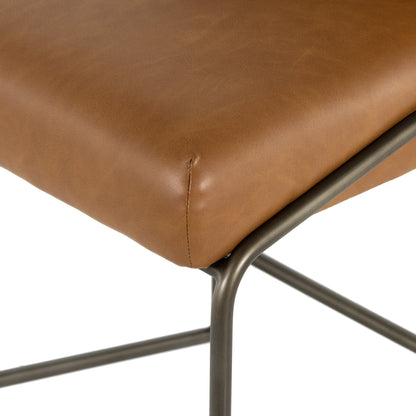 Astrud Bar Stool by Four Hands in sierra butterscotch. Made from faux leather, iron, top grain leather in a modern style.