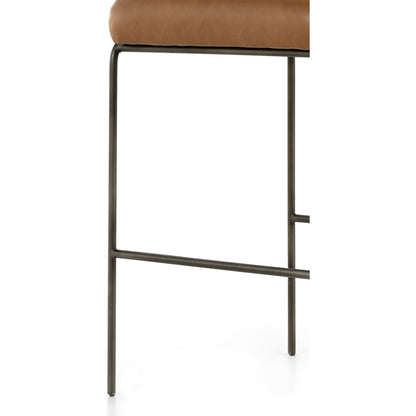 Astrud Bar Stool by Four Hands in sierra butterscotch. Made from faux leather, iron, top grain leather in a modern style.