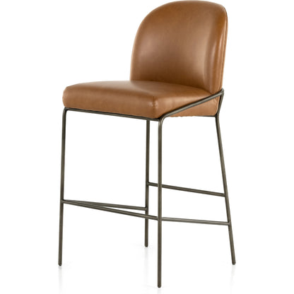 Astrud Bar Stool by Four Hands in sierra butterscotch. Made from faux leather, iron, top grain leather in a modern style.