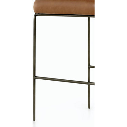 Astrud Bar Stool by Four Hands in sierra butterscotch. Made from faux leather, iron, top grain leather in a modern style.