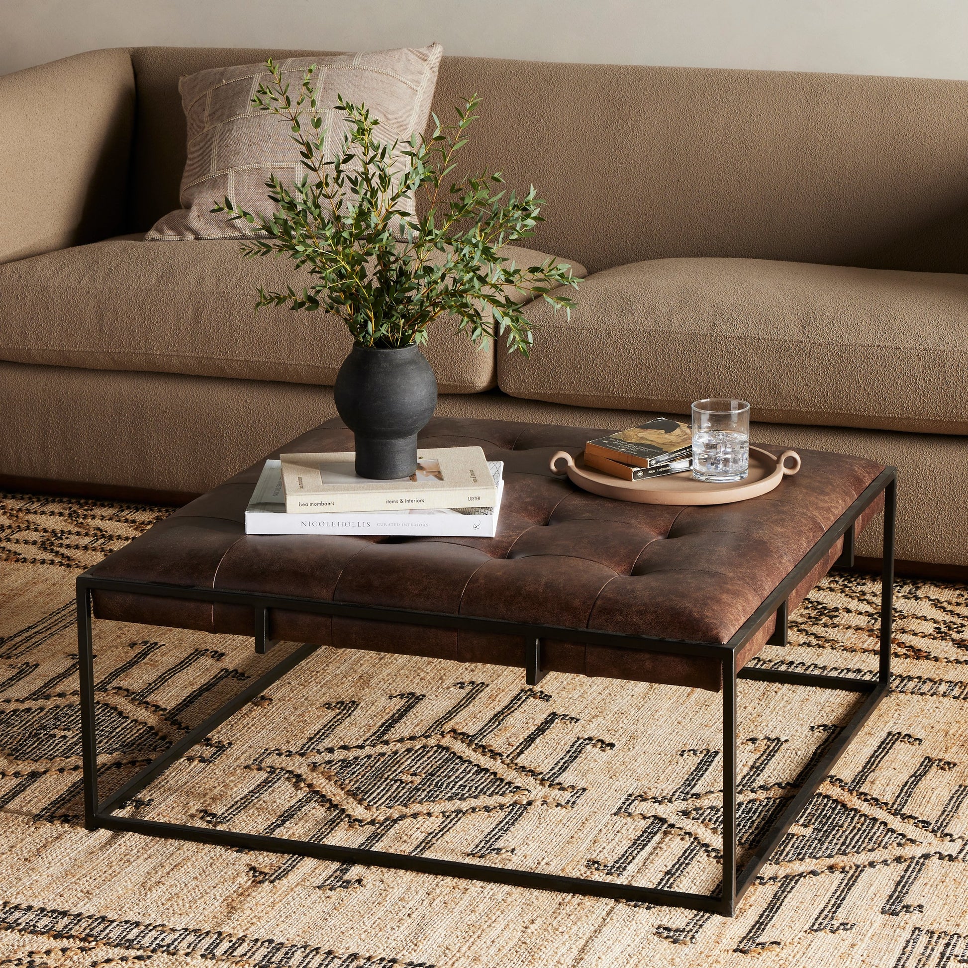Oxford Square Coffee Table by Four Hands in rialto ebony, antique brass. Made from top grain leather, iron, 100% polyester in a modern style.