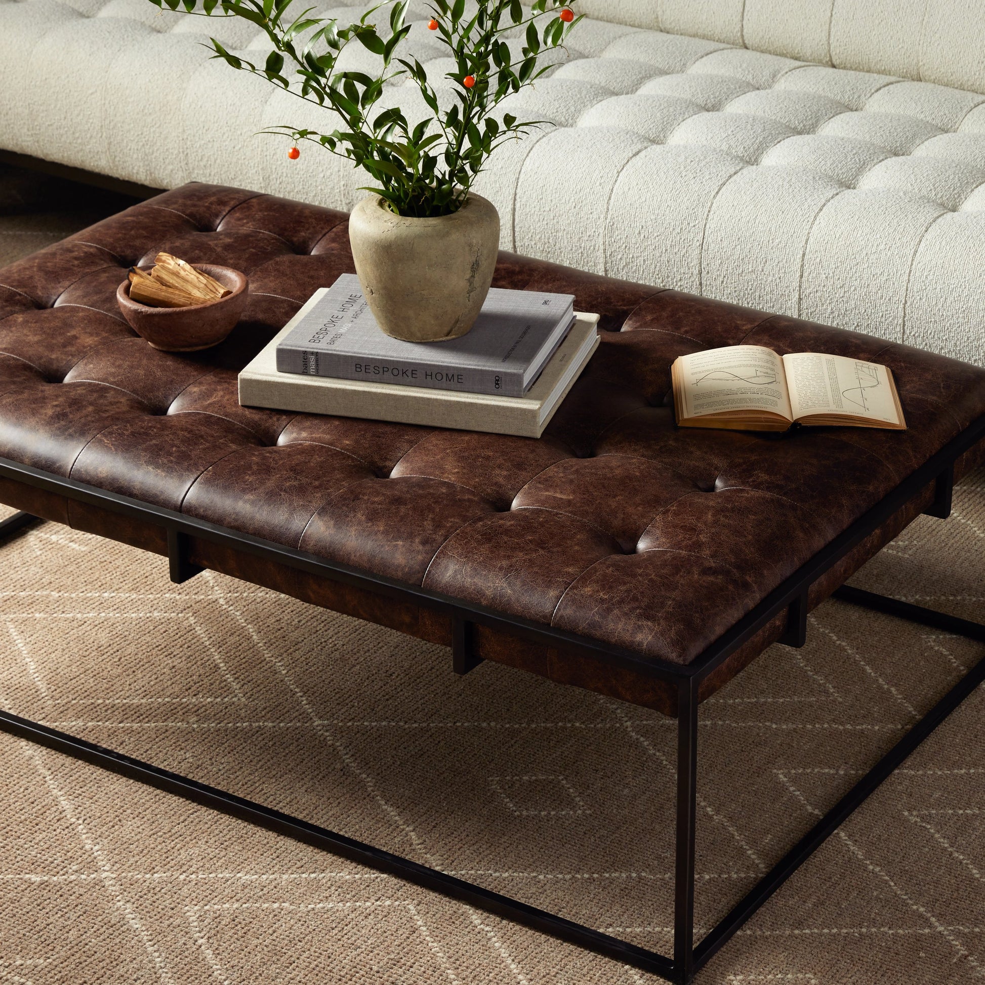 Oxford Coffee Table by Four Hands in rialto ebony and antique brass. Made from top grain leather, iron, 100% polyester in a modern style.