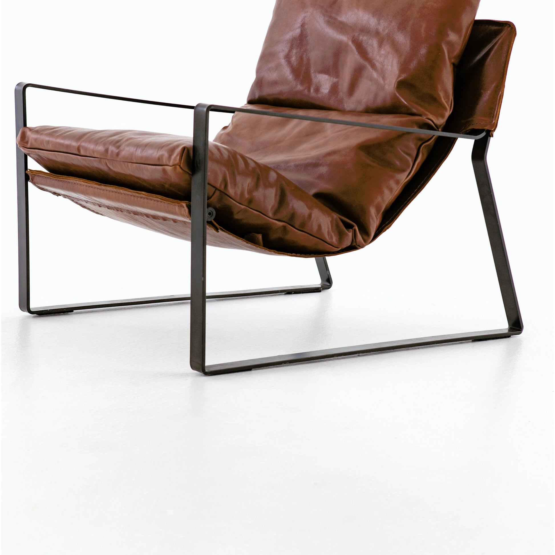 Emmett Sling Chair by Four Hands. Made from top grain leather, iron, 100% polyester in a modern style.