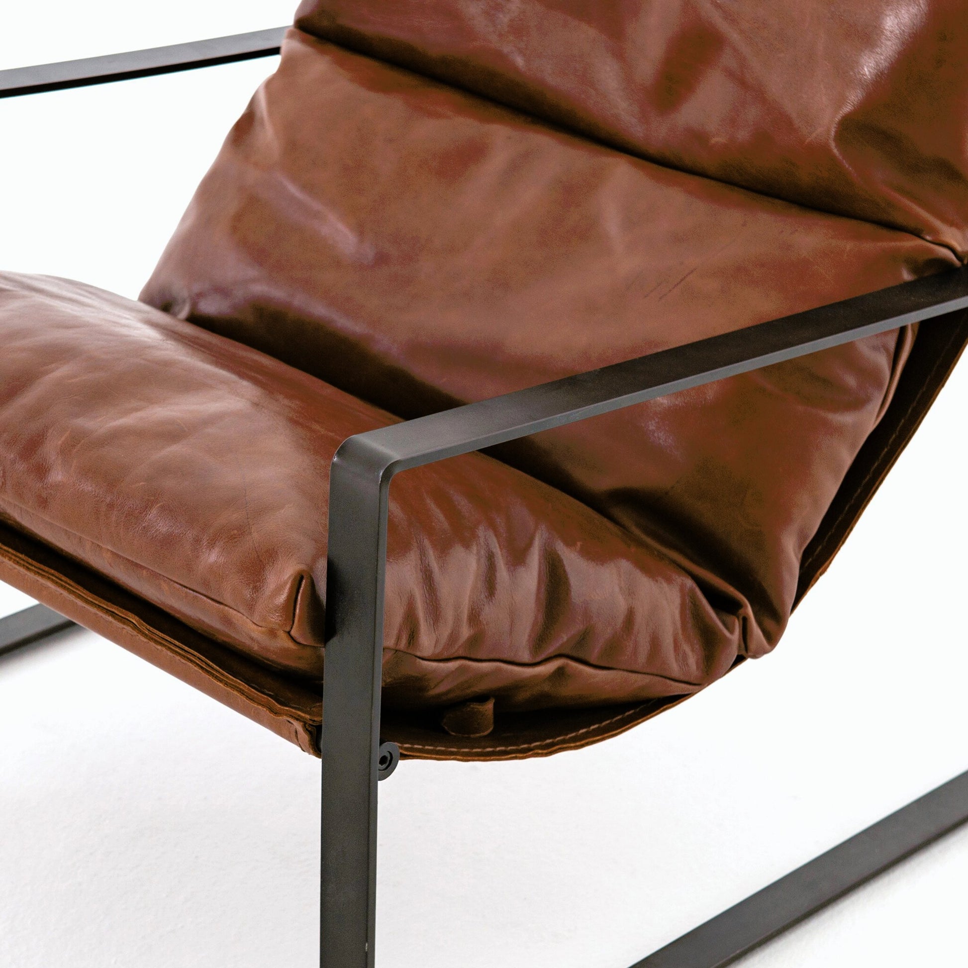 Emmett Sling Chair by Four Hands. Made from top grain leather, iron, 100% polyester in a modern style.